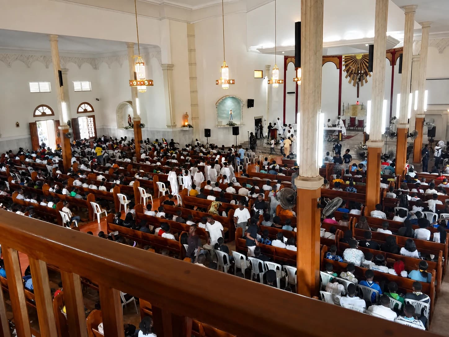 The church nave and congregation at Sainte Berthe, seen from the gallery